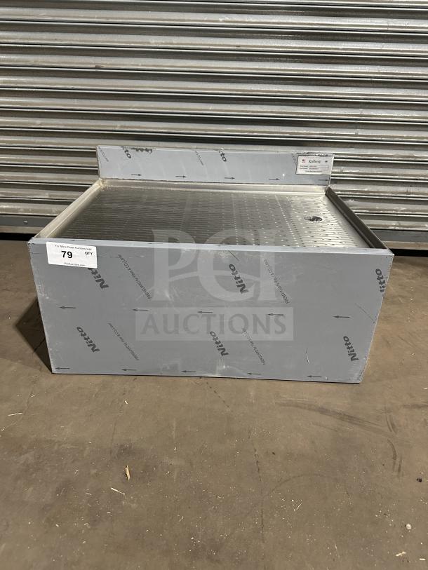 Brand new Krowne KR24-GS30 stainless steel work table with perforated drain board. Model and serial number tags visible.