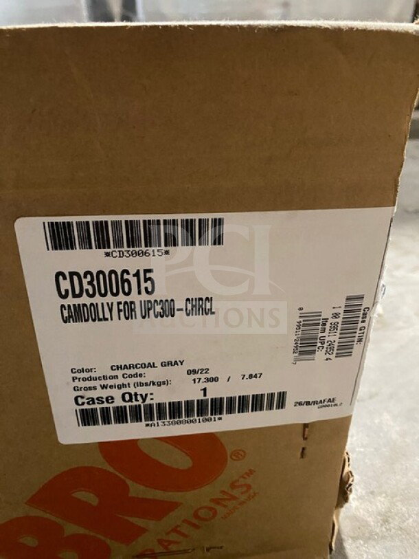 Cambro Cam Dolly Model CD300615 in box. Charcoal gray. Brand new condition. Visible label shows model and production details.
