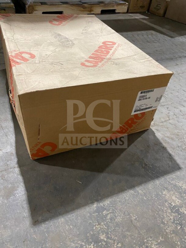 New Cambro Cam Dolly Model CD300615 in box, charcoal gray, visible packaging with labels indicating model and make.