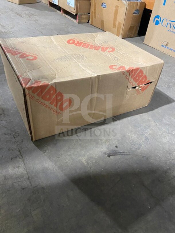 Boxed Cambro Cam Dolly Model CD300615 in charcoal gray, brand new with visible markings on packaging.