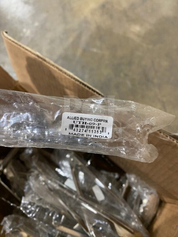 Brand new Allied stainless steel restaurant tongs, wrapped in plastic. Label reads "Allied Buying Corp.," "Made in India."