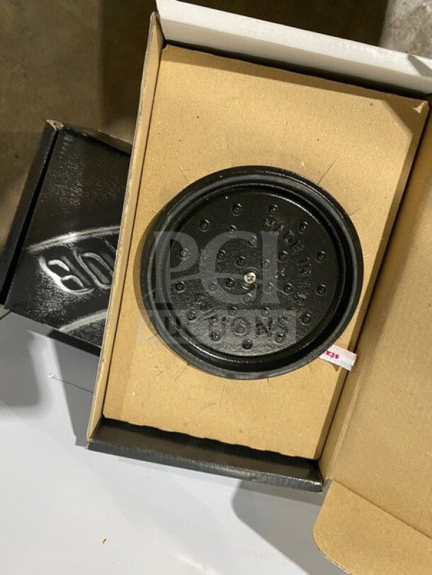 Brand new Staub Cocotte Pot model 1101225 in box. Heavy-duty round design, black with lid, perfect condition.