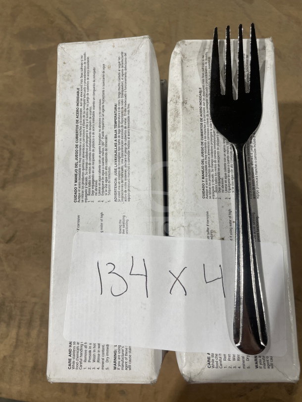 Brand new commercial stainless steel salad fork on boxes labeled "134 x 4," indicating 4 dozen forks in packaging.