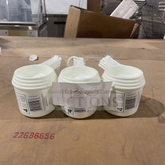 Brand new Winco commercial white measuring cup set, model L38315A0WHT, on display. Visible barcode and model label.