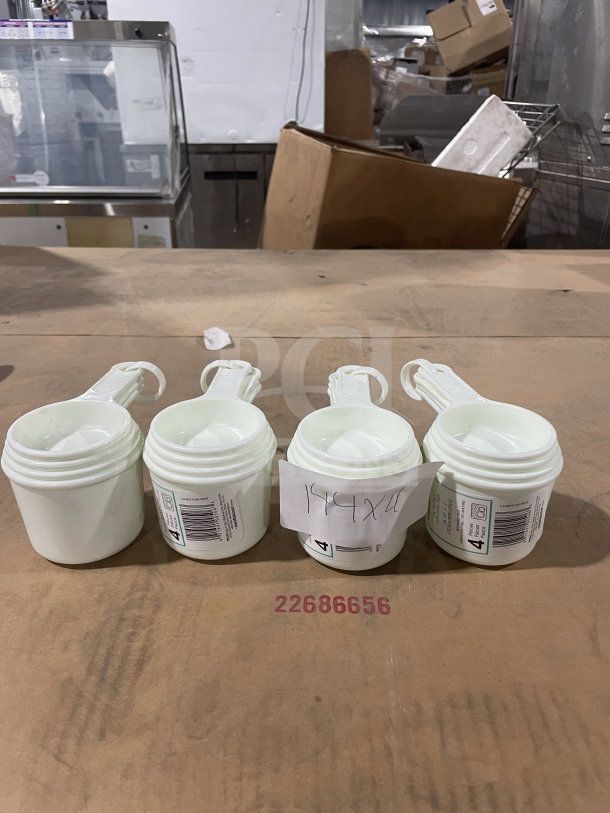 Winco Commercial White Measuring Cup Set, Model L38315A0WHT, brand new, includes four stacking cups with labels.