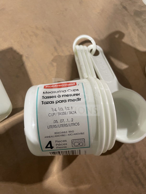 Winco white measuring cup set, model L38315A0WHT, brand new. Includes 4 pieces with removable ring and volume labels.