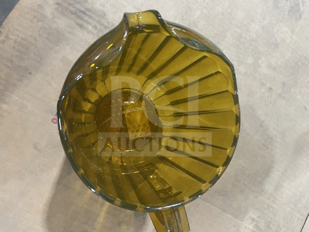 Rubbermaid Commercial Gold Pitcher, Model FG333800GOLD, brand new, amber color, ribbed design, top view.