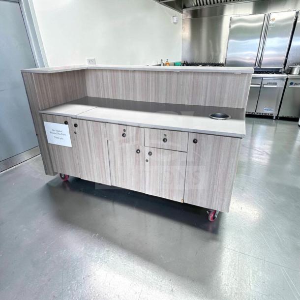 72" custom-built restaurant service counter with storage cabinets, laminate finish, trash cutout, in remarkable condition.