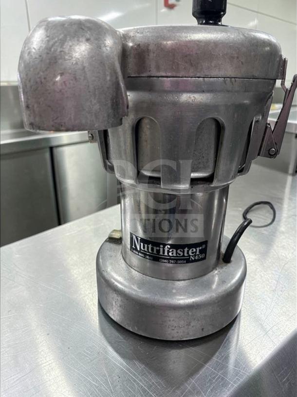 Nutrifaster N450 Commercial Juicer in stainless steel, heavy-duty design. Fully tested, operational with visible model label.