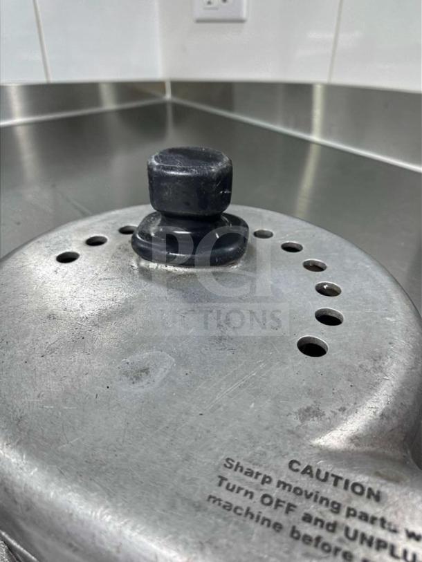 Nutrifaster N450 juicer lid detail, showing stainless steel build and safety caution text.