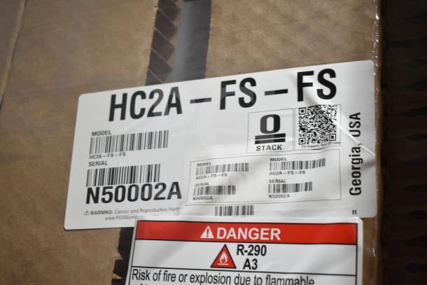 Brand new Hoshizaki HC2A-FS-FS heated cabinet with tag showing model and serial number N50002A, 208/230V, 1 Phase.