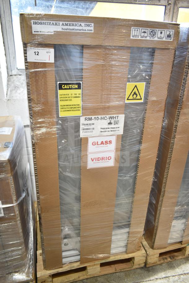 Brand new 2024 Hoshizaki RM-10-HC-WHT glass door merchandiser, one right hinge door, white, in packaging with caution labels.