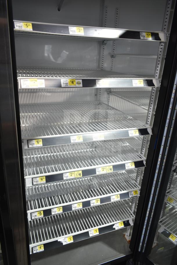 2021 True GDM-72-HC 3 Door Reach In Cooler Merchandiser with glass doors, shelving, and product price tags; tested and working.