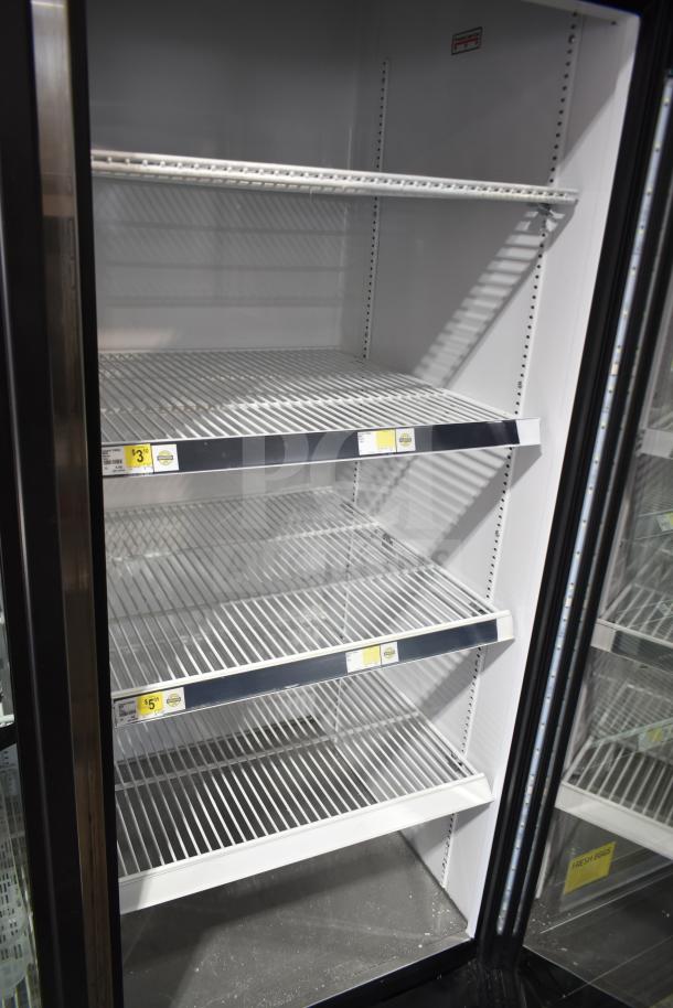 2020 True GDM-72-HC commercial 3 door reach-in cooler merchandiser, tested and working, 115 volts, 1 phase, shelves visible.