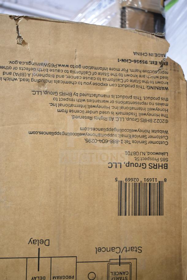 Cardboard box for Honeywell HDS18SS dishwasher, showing barcode and warnings. Box has some tears and wear.