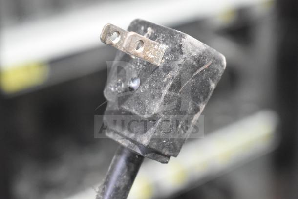Power plug of Everest ETBR2-D4 commercial cooler, showing standard 115V plug in used condition.
