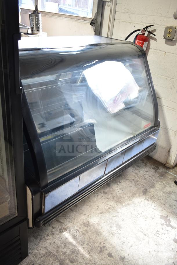 Torrey TEC130L-UL commercial floor deli display case, curved glass front, black trim, 127V, 1 Phase.