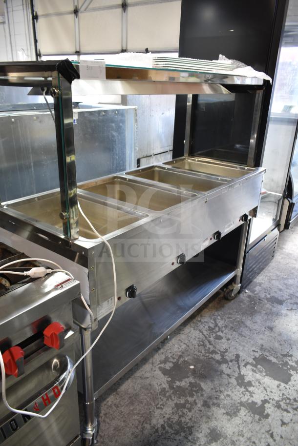 NH-4-240-SU commercial electric 4 well steam table, 240 volts, stainless steel, good condition, visible control knobs.
