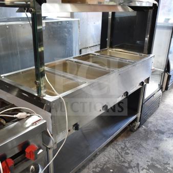 NH-4-240-SU commercial electric 4 well steam table, 240 volts, stainless steel, good condition, visible control knobs.