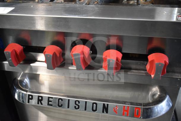 Precision commercial gas range with 4 burners, oven, over shelf, and backsplash. Features red knobs and Precision branding.
