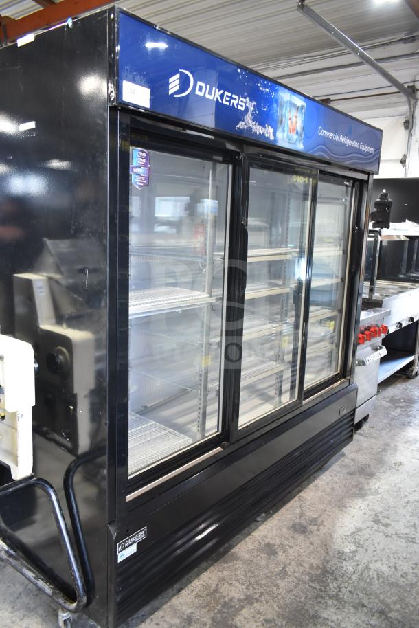 Dukers DSM-68SR 3-door commercial cooler, on casters, 115V, 1 phase. Well-maintained, features shelves and branding.