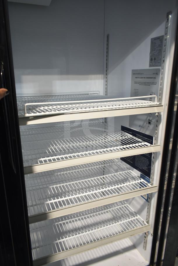 Dukers DSM-68SR commercial 3-door reach-in cooler on casters. Features adjustable shelves, 115 volts, 1 phase.