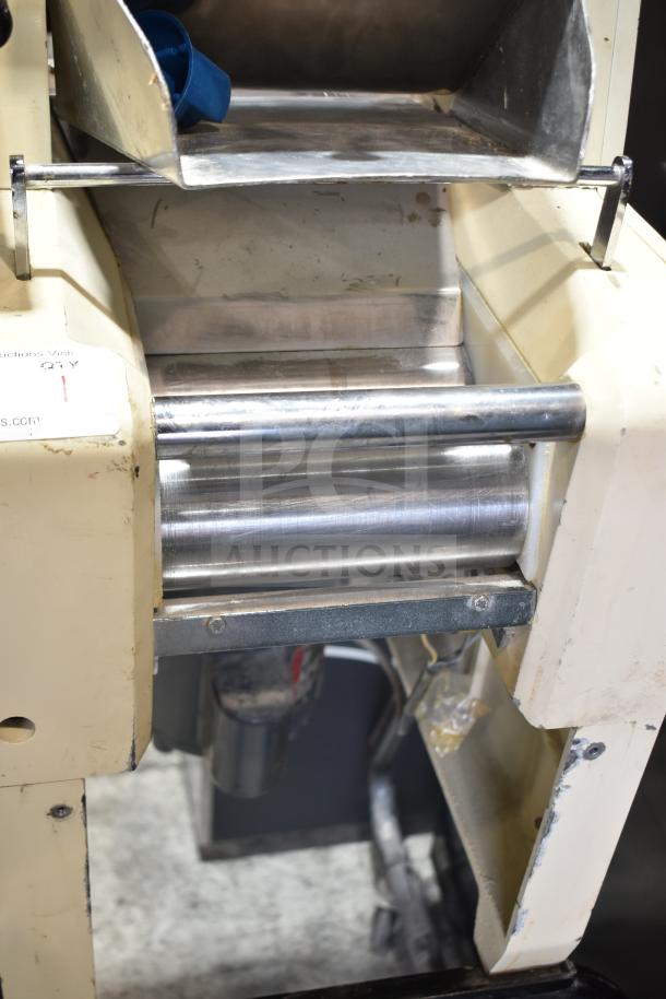 Pasta Mat commercial pasta machine on casters, 208 volts. Features stainless steel rollers. Used condition with surface wear.