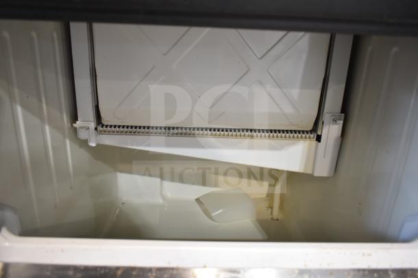 Hoshizaki KM-160BWJ undercounter ice machine interior, clean condition, with scoop visible. 115V, 1 Phase.