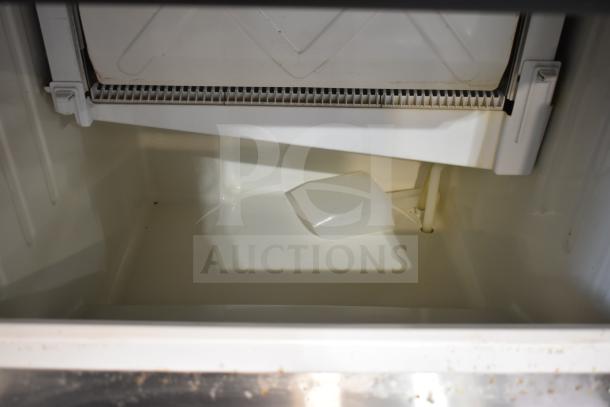 Hoshizaki KM-160BWJ commercial ice machine interior, clean condition, showing ice bin and scoop. 115 volts, 1 phase.