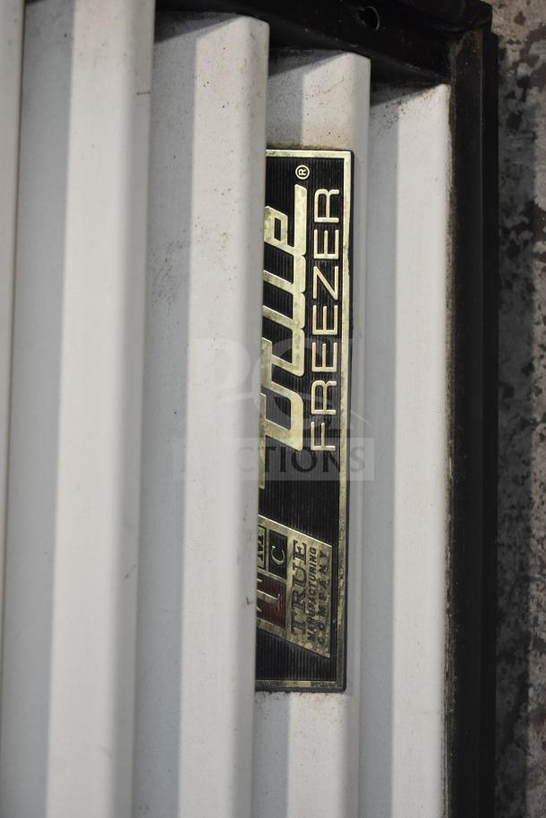 True GDM-49F Commercial Freezer Merchandiser label detail; gold and black branding visible on door edge.