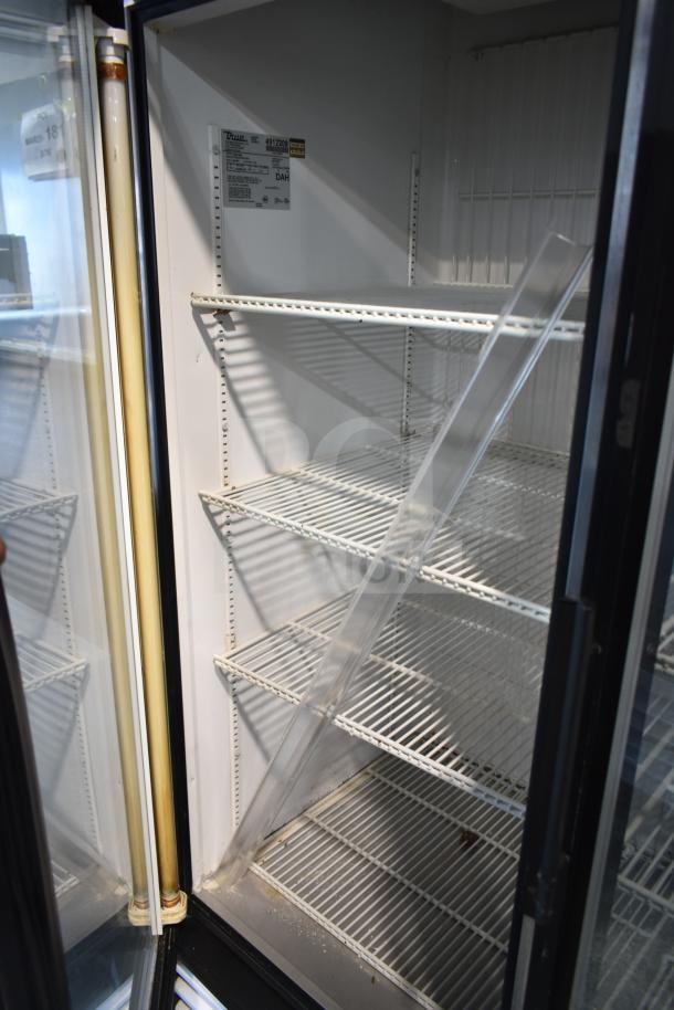 True GDM-49F commercial 2 door freezer, white wire shelves, clear door displays, label indicates specs and model.
