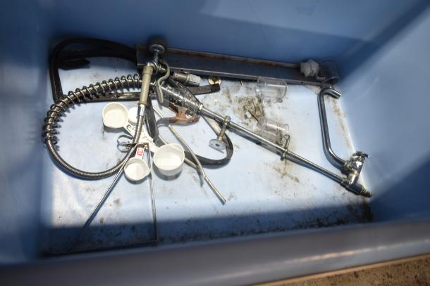 2019 Ice-O-Matic B110PS ice storage bin, 854 lb. capacity. Interior view showing plumbing and parts. Some dirt visible.