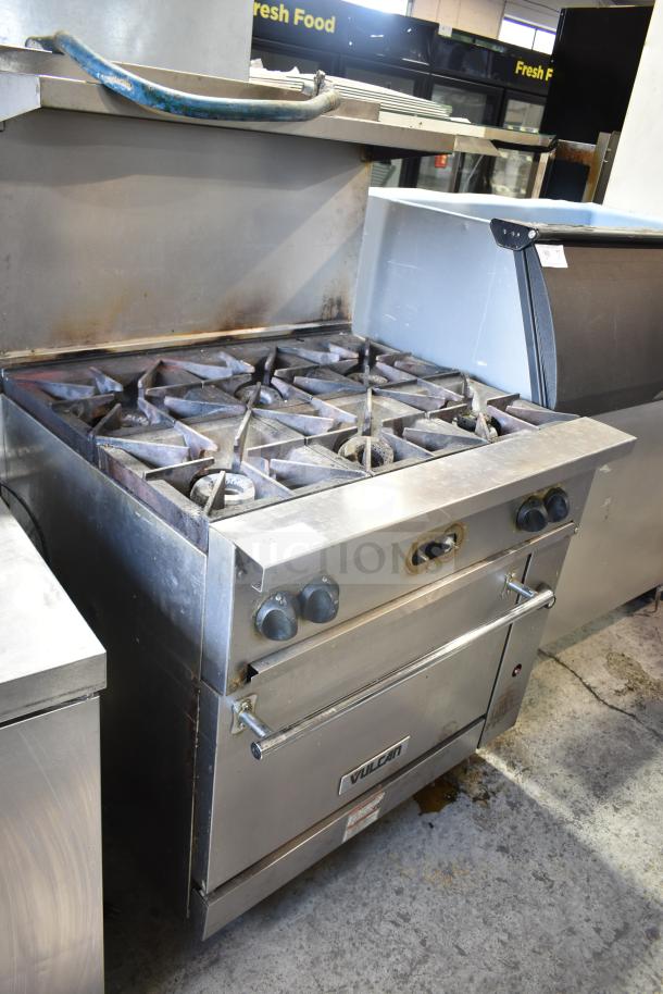Vulcan 36S-6BN commercial gas range with 6 burners, oven, overshelf, backsplash, and casters. Used condition.