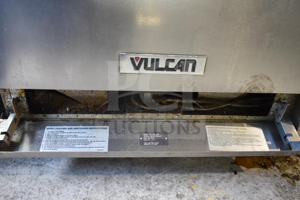 Vulcan 36S-6BN commercial range with 6 burners, oven, overshelf, and backsplash. Features power instructions and markings.