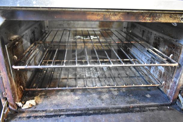 Vulcan 36S-6BN commercial oven interior with wire racks, showing signs of use and wear.