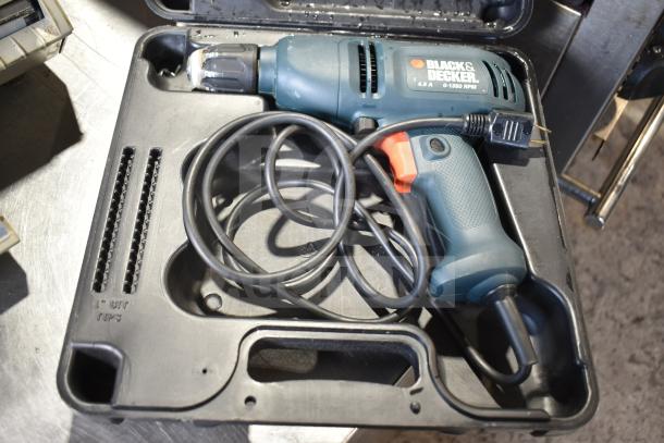 Black & Decker DR220 corded drill in hard case, 10mm, 120V, 1 phase, model DR220, with cord and ergonomic handle.