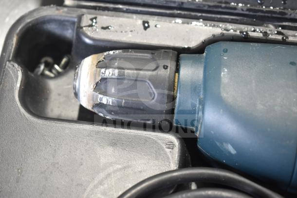 Black & Decker DR220 corded drill, 10mm, 120V, in hard case. Visible signs of wear, includes storage compartment.