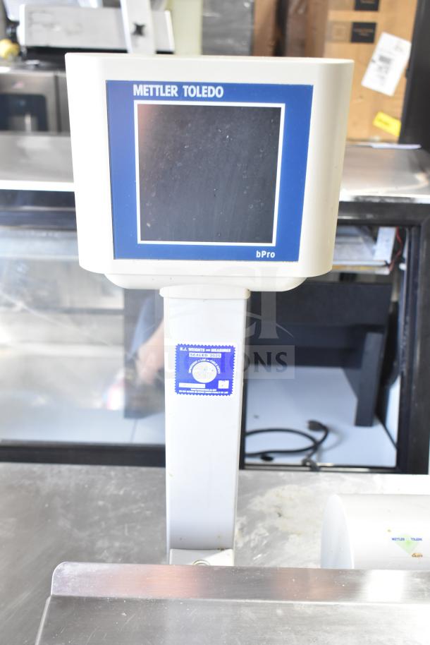 Mettler Toledo bPro commercial food scale, 100V, 1 phase, with display screen and certification label, good condition.