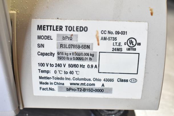 Mettler Toledo bPro commercial countertop food portioning scale label, showing model and serial number. Capacity: 6/15 kg.