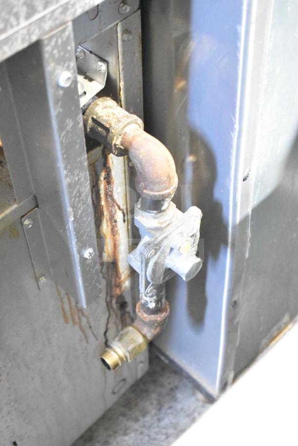 Commercial natural gas connector on Precision RGR60-GS24-P, showing rust and wear. For 6 burner range maintenance.