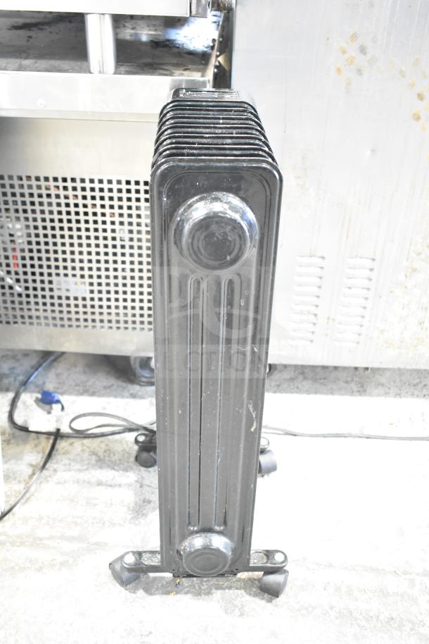 MainStays WSH07O2ABB electric radiator heater, black, upright position, visible plug; part of 2-item auction with Air King fan.
