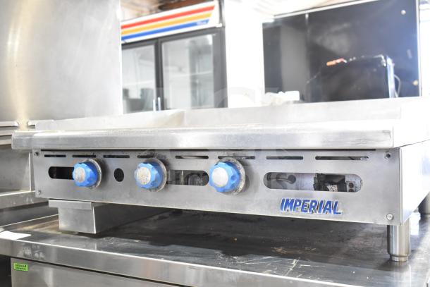 Imperial Commercial Countertop Gas Griddle, stainless steel, blue knobs, "Imperial" logo, used condition.