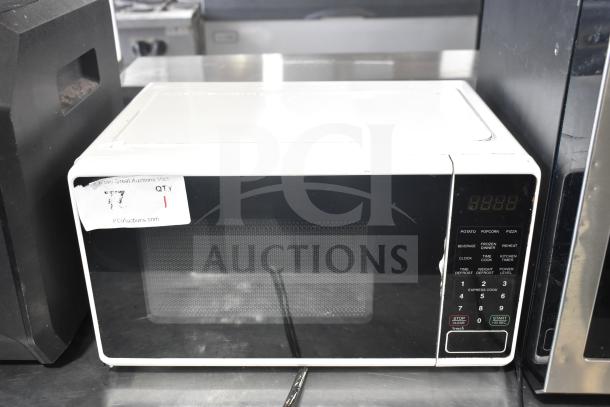Hamilton Beach MSF0W100072352 microwave oven, countertop model, 120 volts, visible controls, minimal wear, auction label present.