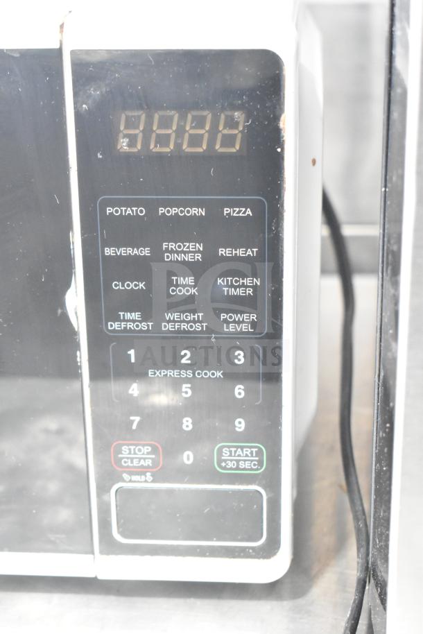Hamilton Beach MSF0W100072352 countertop microwave, 120V, features keypad options like popcorn, defrost, and timer.