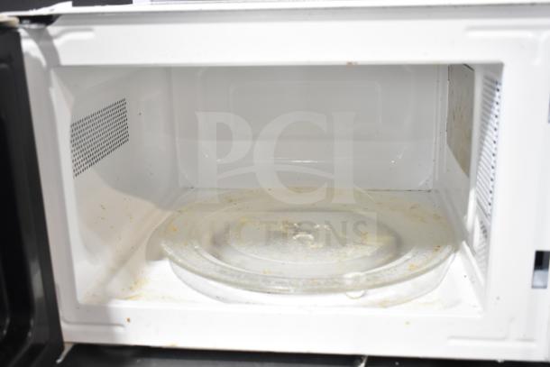 Hamilton Beach MSF0W100072352 Countertop Microwave Oven, 120V, interior view showing used condition with stains.