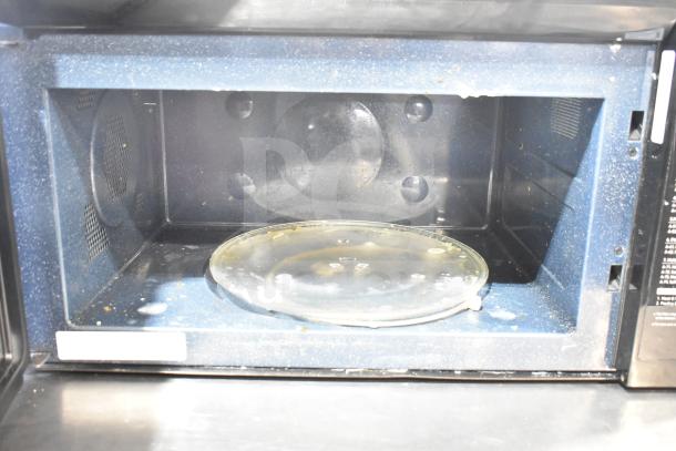 Samsung MC17T8000CS microwave interior, showing turntable. Used condition with visible wear and residue. 120 Volts, 1 Phase.