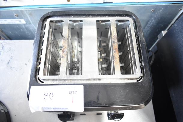 Black & Decker TR7847-18D 4-slot toaster, countertop model, 120 volts, visible wear, auction label attached.