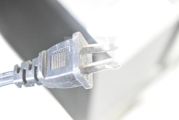 Close-up of a two-prong electrical plug. Connected to one of four items, including a Chung Yuan TF-810S fan, Lasko heaters, and a Vornado fan. 120 volts, 1 phase.
