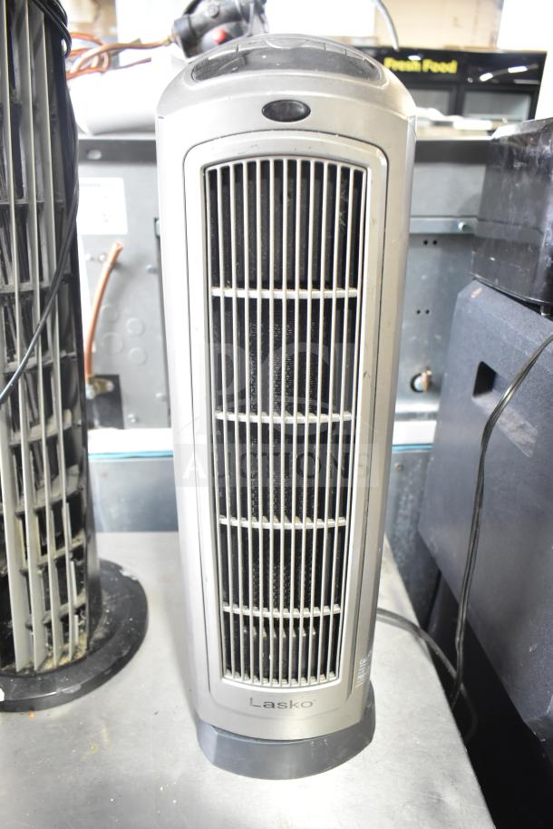 Lasko 755320 heater with control panel and vent, silver finish. Visible power cord, tabletop placement, good condition.