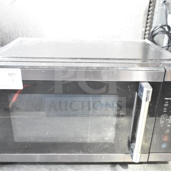 Hamilton Beach HB61B100027880 countertop microwave oven, shows signs of use. Features digital controls, 120 volts, 1 phase.